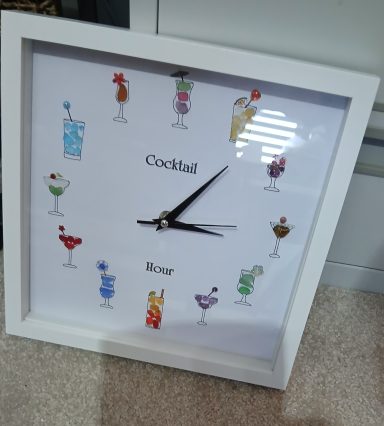 Clock with sea glass and has cocktail hour on the face of the clock